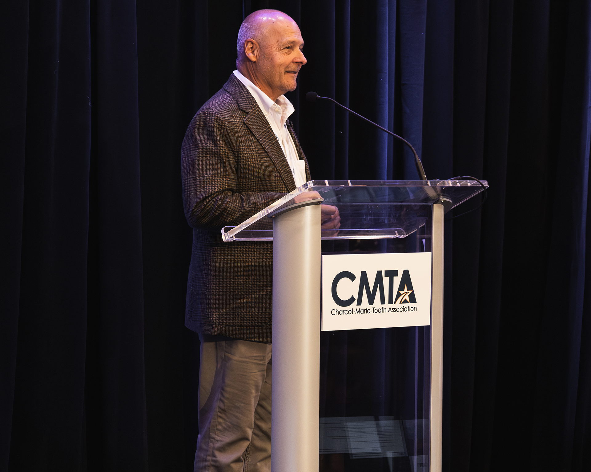 Ken Cornell standing at a podium that reads: CMTA Charcot-Marie-Tooth Association
