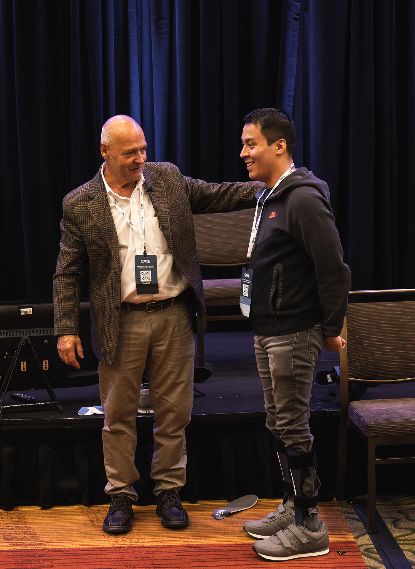 Ken Cornell standing next to smiling man with two foot braces on